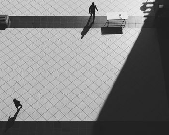 Silhouette people walking on road