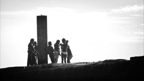 Low angle view of people against clear sky