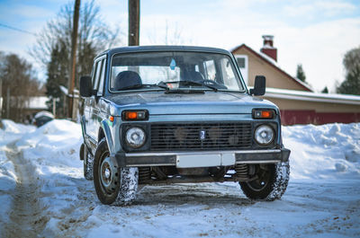 Vintage car on snow covered field