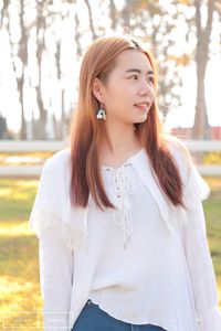 Portrait of a beautiful young woman standing outdoors