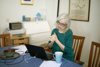 Woman using laptop at home