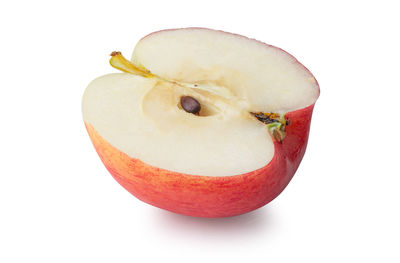 Close-up of apple on plate against white background