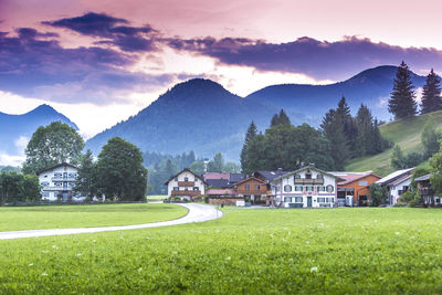 Houses by mountains against sky