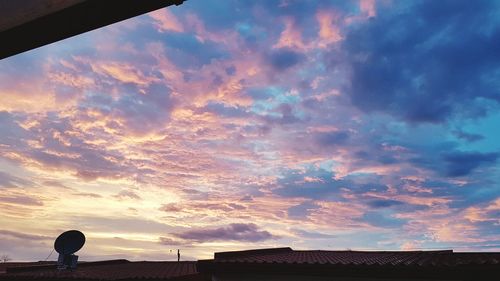 Dramatic sky over town during sunset