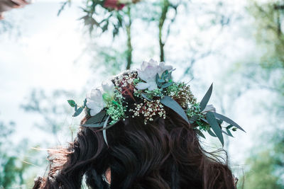 Portrait of woman with pink flowers on tree