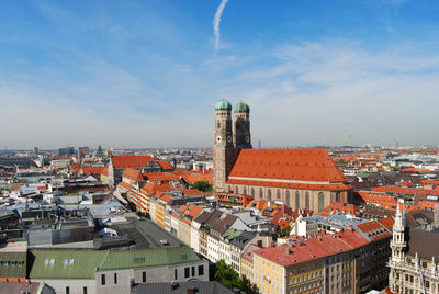 Munich cathedral with cityscape against sky