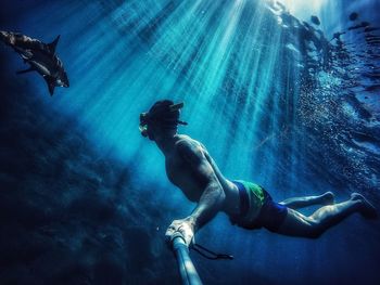 Low angle view of man swimming in sea