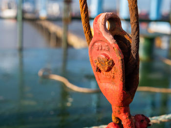 Close-up of rusty metal railing by river