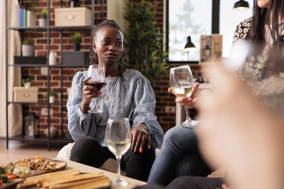 Portrait of smiling young woman having food at restaurant