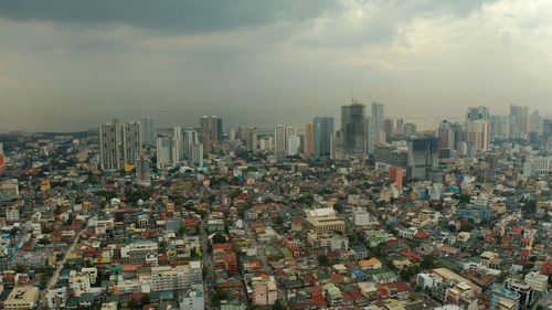 Aerial view of modern buildings in city against sky