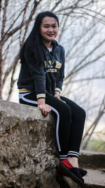 Portrait of a young woman sitting outdoors