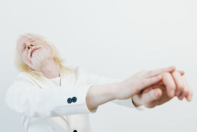Rear view of woman gesturing against white background