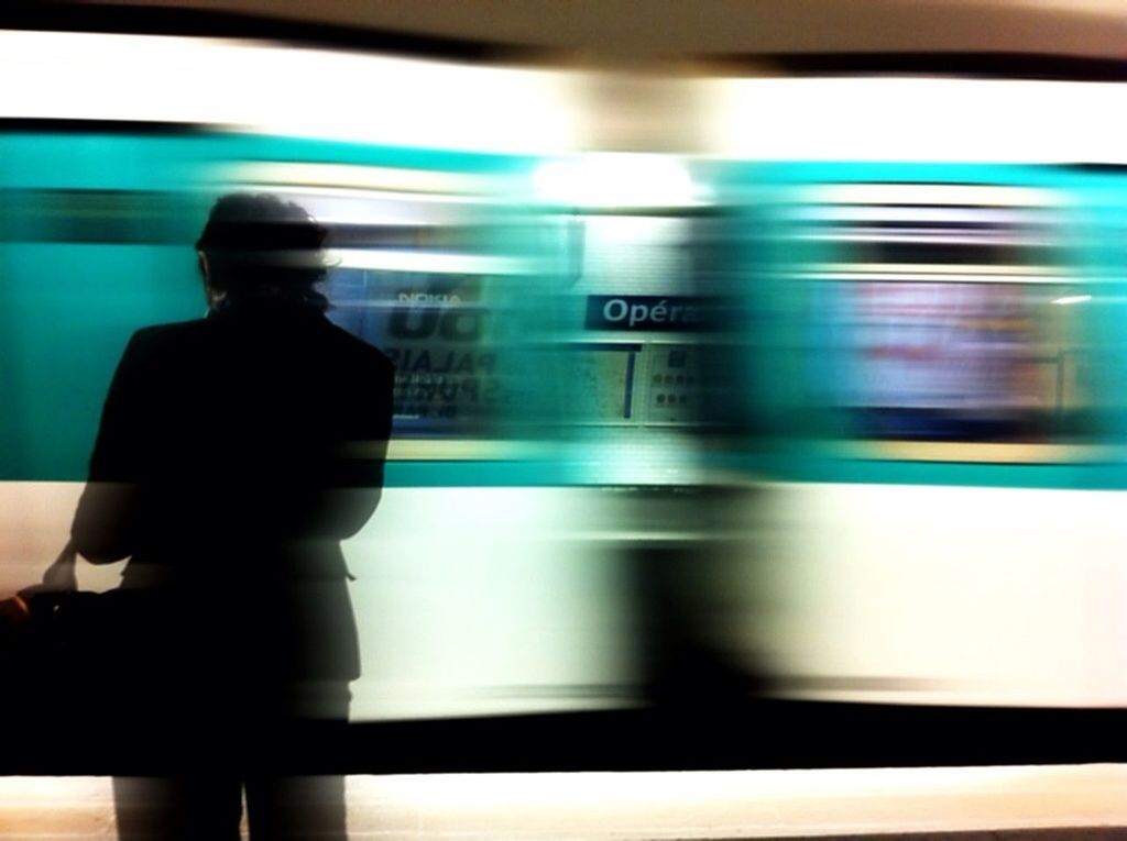 transportation, public transportation, indoors, mode of transport, train - vehicle, railroad station, railroad station platform, travel, rail transportation, blurred motion, vehicle interior, passenger train, train, subway station, on the move, motion, passenger, illuminated