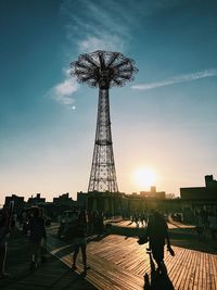 Silhouette of amusement park ride at sunset