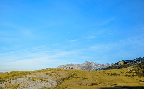 Scenic view of landscape against blue sky