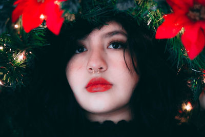 Portrait of young woman with christmas tree