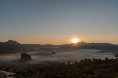 Scenic view of sunset over land