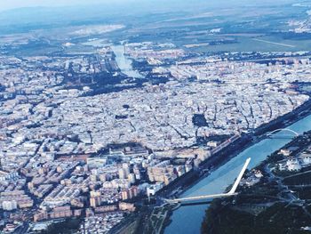 High angle view of illuminated city by river