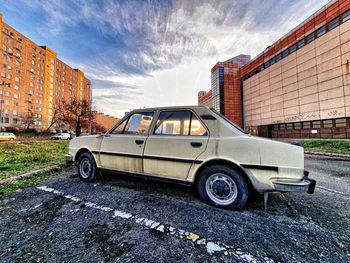 Car parked on street against buildings