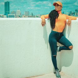 Full length of young woman looking away in city