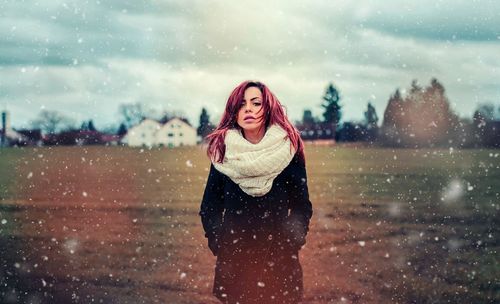 Portrait of a smiling young woman in snow