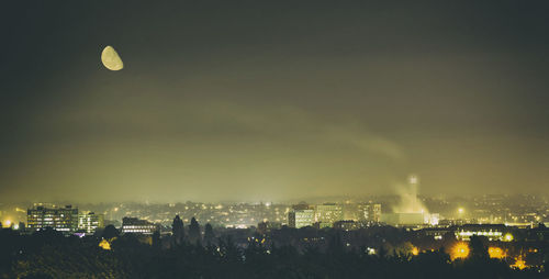 Aerial view of illuminated buildings in city at night