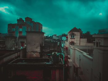 Old buildings in city against sky at dusk