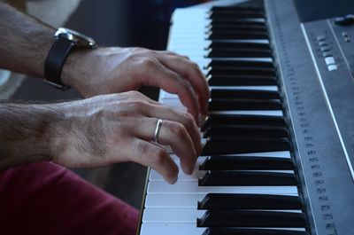 Close-up of man playing piano