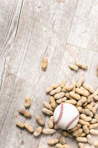 High angle view of baseball equipment on wooden table