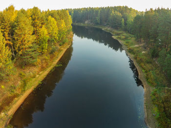 Scenic view of lake by trees against sky