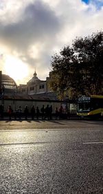 People on street in city against sky