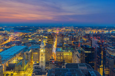 High angle view of illuminated buildings against sky at sunset