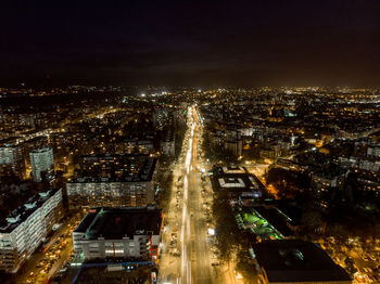 High angle view of illuminated city buildings at night