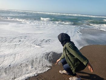 Side view of a boy looking at sea shore