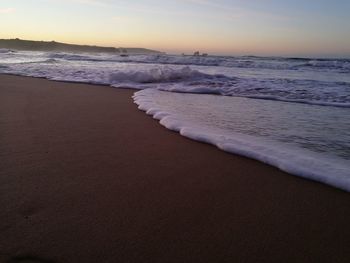 Scenic view of beach against sky during sunset