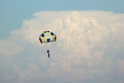 Low angle view of paragliding against sky