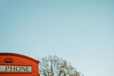 Low angle view of information sign against clear sky