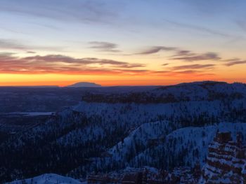 Scenic view of snow covered mountains against sky during sunset