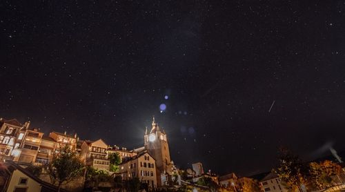 Illuminated cityscape against sky at night