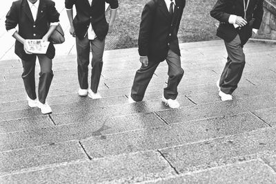 Low section of people walking on footpath