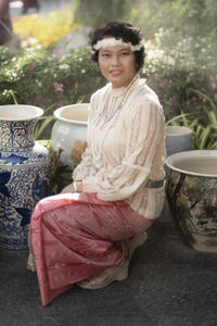 Portrait of a smiling young woman sitting outdoors