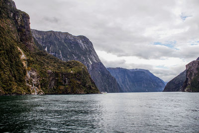 Scenic view of sea and mountains against sky