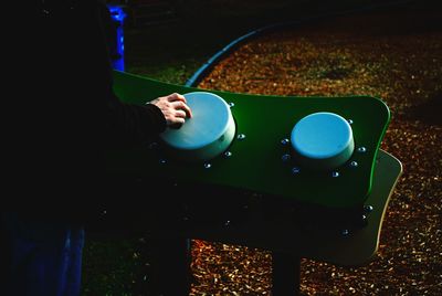 Midsection of person touching blue push button