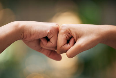 Cropped image of couple holding hands