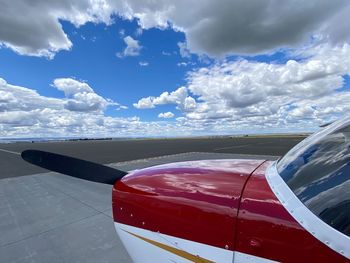 Airplane flying over sea against blue sky