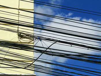 Low angle view of glass building against sky