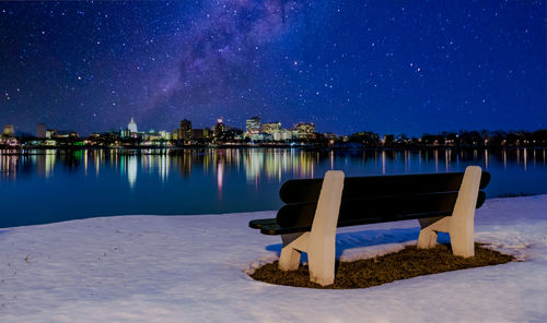 Lifeguard hut on lake against sky at night