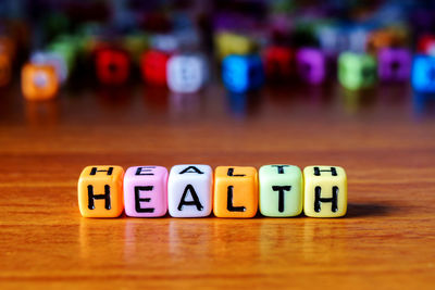 Close-up of text on multi colored toy blocks table