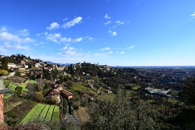View of cityscape against blue sky