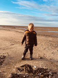 Full length of boy standing at beach